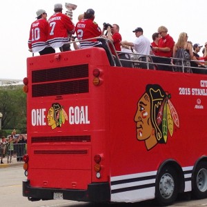 The bus carrying the champion Blackhawks passes with Brent Seabrook holding the Stanley Cup. Photo by Sarah Surch Green