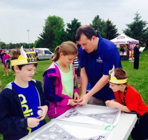 Sam, Anna, Ed and Henry Kuhner from Cary work on a kite, during the annual Kite Festival in Crystal Lake.