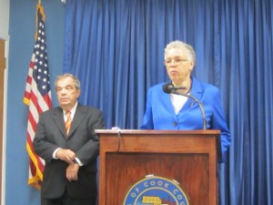 Cook County Board President Toni Preckwinkle speaks to the media after Wednesday's board meeting about her proposal to raise the Cook County sales tax rate by 1 percent. Looking on is County Commissioner John Daley, chairman of the county's Finance Committee. Photo by Kevin Beese/for Chronicle Media