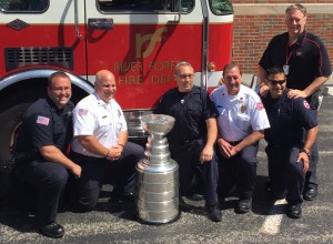 Members of the River Forest Fire Department pose with the Stanley Cup on July 15 in the parking lot of First Presbyterian Church of River Forest. More than 1,000 people visited the church to have their photo taken with the Stanley Cup as a fundraiser. Chronicle Media photo by Rick Hibbert