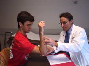 Dr. Mark Cohen of Midwest Orthopaedics at Rush meets with Jeff Wolfe, 18, a pitcher from LaGrange Highlands, who had Tommy John surgery in July. (Photo courtesy of Midwest Orthopaedics) 