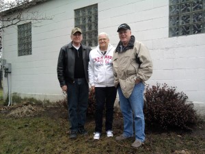 In a photo dated from 2013, (from left) John Huemann, Karen McEvoy, and Mike McEvoy stand by a side wall of the Schmitt chapel on Chapel Hill Road in Johnsburg. Huemann, also a village trustee, and McEvoy, care for the structure, which dates back to the 1840s. Photo by Greg Harutunian