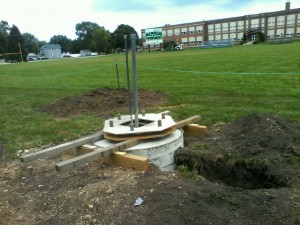 The concrete footings and pole standard bases have been poured. School officials are looking at erecting the actual poles and the lights Aug. 22, well ahead of the first home game.