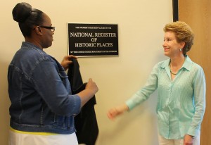 Cynthia Smith, Lincoln Library branch manager, and Margaret Cousin, Peoria Public Library Board Trustee, unveil the plaque recognizing the Lincoln Branch as being placed on the National Register of Historic Places. (Photo courtesy of Peoria Public Library)