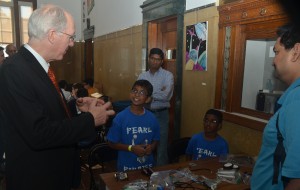 U.S. Rep. Bill Foster (left) greeted Siddhanth Pattisapu. 9, of Aurora (second from left) at Illinois regional finals of the World Robot Olympiad (WRO) held last month SciTech Hands On Museum in Aurora. Pattisapu, a student at Aurora University’s STEM school, was a member of the third-place Pearl Pirates team. Four teams totaling 10 elementary to middle-school students qualified for WRO national finals at Lawrence Technological University in Southfield, Mich. Students built computer-programmed Lego robots in the competition sponsored by Aurora-based Chasewood Learning. (Al Benson photo)