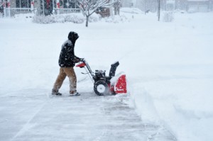 An unidentifiable person Snow Blowing During Blizzard in Deep Accumulation of Snow