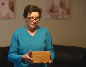 Linda Hayes holds a wooden box that contains cremated human remains, but she doesn't believe they are her husband's. Linda Hayes lost her husband Tom about two years ago at age 56, and after donating his body to science, discovered that the FBI had found his remains at a company under investigation. Friday, December 18, 2015, in Elk Grove Village, Illinois. (Jon Langham-for Chronicle Media)