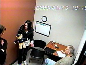 Calusinski with a teddy bear, given to her by interrogators to demonstrate her movements with the child. (photo taken from interrogation tapes) 