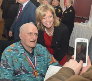 Elgin resident Everitt Schlegel, left, posed for photos and greeted guests at a 46th annual Pearl Harbor memorial luncheon in Aurora last week. 