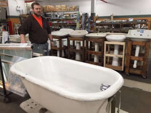 Marcus Hayes, operations manager at ReStore Chicago shows off bathroom fixtures at the discount construction recycling store. (Photo by Jean Lotus/Chronicle Media)