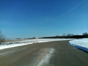 The winding main drive betrays the fallow lots of the Whispering Ridge Estates of Johnsburg subdivision, the subject of litigation between the Village, and the State Bank Group over uncompleted infrastructure improvements. (Photo by Gregory Harutunian/for Chronicle Media)