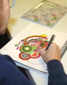 Denise Day of Eureka colors in an original design she created at an adults-only coloring night at the Eureka Public Library. While adult coloring books are a fairly new trend, Day said she’s been designing her own coloring sheets since 1971. (Photo by Elise Zwicky)
