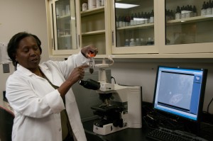 Toni Gymph-Martin, microbiologist for the Water Reclamation District, holds a water test sample. (Photo courtesy of Metropolitan Water Reclamation District)