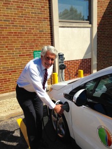 Kane County Board Chairman Chris Lauzen uses the car charging station at the county government building in Geneva. (Photo courtesy Kane County)