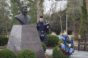 A lone bagpiper plays during a wreath-laying ceremony in the Ronald W. Reagan Peace Garden. (Photo courtesy Eureka College)