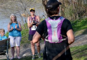 Jennifer Kirkolis (left) and Mare[ql] Potts (515) clap for runners finishing the race during the Saw Wee Kee Spring Trail Challenge at Saw Wee Kee Park in Oswego on Saturday, April 16, 2016. Photo by Steven Buyansky
