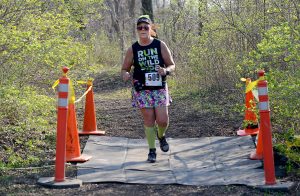Allison O'Connor (509) crosses the finishline during the Saw Wee Kee Spring Trail Challenge at Saw Wee Kee Park in Oswego on Saturday, April 16, 2016. Photo by Steven Buyansky
