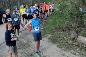 Oswegoland Park District Special Events Supervisor Kristie Vest (left) gets ready to start the first runner, Alan Ward (501) during the Saw Wee Kee Spring Trail Challenge at Saw Wee Kee Park in Oswego on Saturday, April 16, 2016. Photo by Steven Buyansky