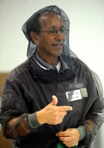 James Theuri, Extension educator for Local Food Systems and Small Farms Unit, wears his protective bee netting during an University of Illinois Extension Service program on beekeeping in St. Charles on Wednesday, April 20. (Photo by Steven Buyansky/for Chronicle Media) 