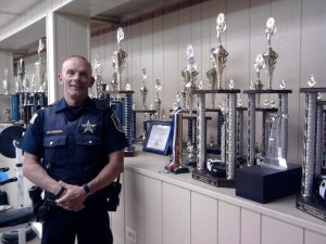 Fox Lake police Lt. Charles Gliniewicz led the department's Explorer Post 300, with headquarters in the basement of the former Lions Club building. The trophy collection represents the winning efforts of the post members in nationwide competitions related to law enforcement practices. (Photo by Gregory Harutunian/for Chronicle Media)