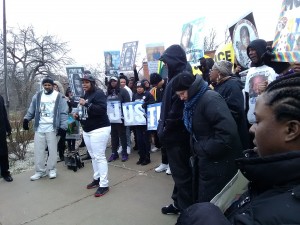 LaToya Howell speaks to the crowd gathered in front of the Zion Police Department.