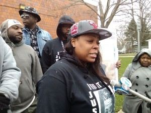 Latoya Howell speaks to the media, following a rally and march marking the one-year anniversary of her son's shooting death.