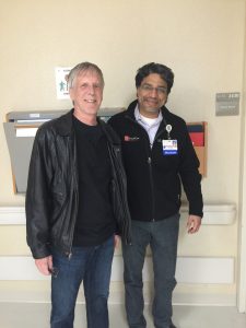 Outside OSF Saint Francis Medical Center, Stephen Heinemann stands with his transplant surgeon, Dr. Manish Gupta. 