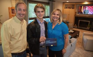 : Ryan Goldsher (from right), 19, of Northbrook and a 2015 Glenbrook North High School graduate, with his parents Linda and Steve Goldsher at home in Northbrook May 18, 2016. Goldsher won $10,000 for his celebrity impressions on the USA Network show “First Impressions,” a competition show featuring comedian Dana Carvey.