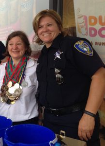 Officer Kathy Eiring, 48, of the Cary Police Department (right) — seen with 2015 Olympic participant Coral Brady — became involved in the annual event 10 years ago, just three years after she joined the CPD. (Photo by Adela Crandell Durkee/for Chronicle Media)