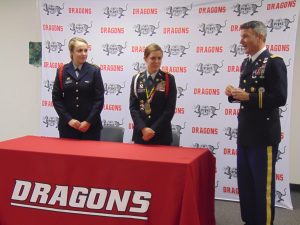 Lt. Col. Lawrence. W. Hallstrom (right), Pekin Community High School JROTC senior Army instructor, introduced Cadet Kelsie Taylor (left) and Cadet Victoria Lodge, who were awarded Army ROTC National High School scholarships. (Photo courtesy of Pekin Community High School JROTC)