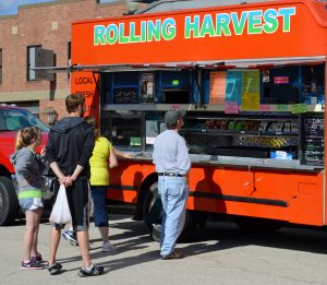 Guests order from the Rolling Harvest food truck during Sycamore's farmer's market last week. (Photo by Jessi LaRue / for Chronicle Media)