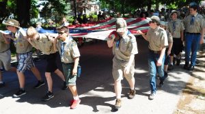 Boy Scouts carry an oversized American flag down South Main St. last Monday during the Oswego Memorial Day parade. (Photo by Jack McCarthy / Chronicle Media)