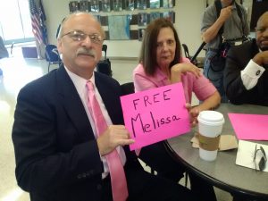 Paul Calusinski, and his sister, Helen Barrett, hold a “Free Melissa” sign in the Lake county courthouse, prior to the June 13 hearing.