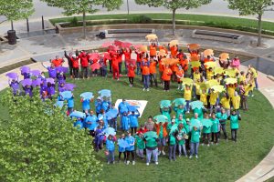 The  Autism McLean campaign reached an official culmination May 14, with an event at the Uptown Station within Normal. About 90 people attended the celebratory event by forming a colorful circle. (Photo courtesy Torii More) 