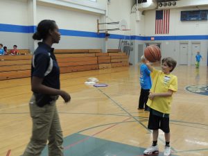Rockford Police Dept. Officer Courntey Tillmon plays basketball with kids at the RPD's summer Safety Camp. (Photo by Lynne Conner/for Chronicle Media)