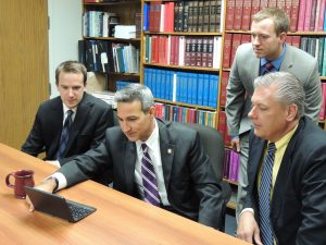 Winnebago County State's Attorney, Joe Bruscato  (seated at computer) meets with his staff (from left) Assistant SA, David  Smith; Assistant SA, Patrick Gibson and Deputy SA, Jim Brun. (Photo by Lynne Conner/for Chronicle Media) 