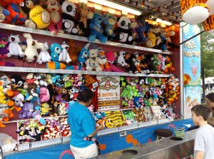The prizes are enticing, but it takes some skill and patience to win any of the rewards at this Kane County Fair Midway vendor during a recent County Fair. (Photo by Jack McCarthy / Chronicle Media)