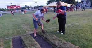 Participants in last Thursday’s farewell to East Aurora High School’s Roy E. Davis Field had a choice of keepsakes — a piece of turf or an asphalt square from the surrounding track. (Photos by Jack McCarthy / Chronicle Media). 