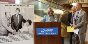 Duane Carlson (left), Pam Davis and Rep. Bill Foster (D-Ill.) unveil a plaque, “Birthplace of Medicare,” that will be on display at Edward Hospital to commemorate the nation’s first Medicare beneficiary, Lillian Grace Avery, who was a patient at Edward Hospital on July 1, 1966.