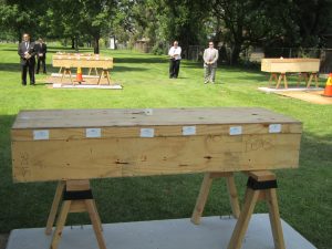 Caskets are placed on sawhorses for the burial service. (Photo by Kevin Beese/for Chronicle Media)