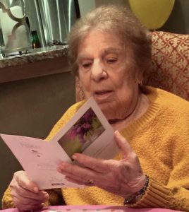 Clara Nycz, 90, looks over one of the many cards she regularly receives from children. Nycz moved into Symphony at the Tillers nursing home in Oswego in July and the cards and notes have made a real difference in her mood, according to her family. (Photo by Erika Wurst/For Chronicle Media)