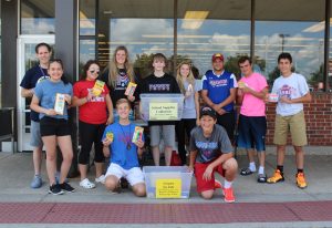 Collecting school supplies for the Crayons for Kids project are Marmion Campus Minister Mark Malkowski (Marmion ’08) at left and Mary Clare Koebel (Rosary '19) fourth from right, with volunteers from Marmion and Rosary at Jewel-Osco on Galena in Aurora. (Photo courtesy of Rosary H.S.)