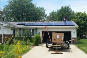 Crews install solar panels on a McLean County home. The Normal-based Ecology Action Center is working to spread information about the long-term benefits of solar power for residents. (Photo courtesy Grow Solar Midwest)