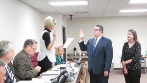 The newest member of the McLean County Board Josh Barnett is sworn into office on Aug 16. His wife, Jenny Barnett, is to his right. (Photo courtesy of McLean County Board)