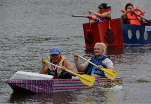 Tom Asavarachan (left) and Kylie Knur paddled the “U-SS of A” in the 14th annual Fox Valley United Way cardboard boat race at Mastodon Lake at Phillips Park in Aurora last Saturday.  The 29-boat, nine-division race kicked off  FV United Way’s annual fundraising campaign. (Al Benson photo)