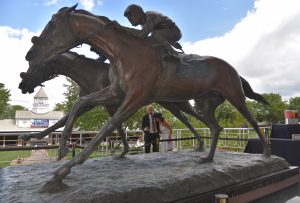 The statue Against All Odds is a Pokemon Go Stop. Anthony Korish of La Crosse, Wisconsin and Jordyn Hedberg of Waseca, Minn., access the Pokestop with a cell phone at Arlington International racecourse in Arlington Heights on Aug. 13, 2016. (Photo by Karie Angell Luc/ for Chronicle Media) 