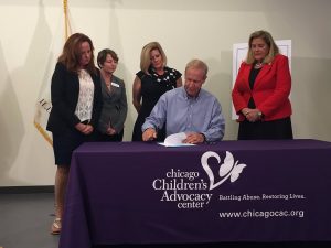 State Sen. Karen McConnaughay  (third from left) watches as Gov. Bruce Rauner in August signed into law two bills aimed at reducing the number of  victims of human trafficking in Illinois. (Photo courtesy of State Sen. McConnaughay Twitter) 