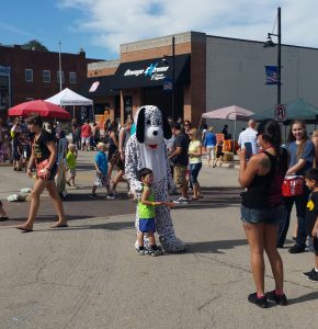 Several costumed characters roamed around downtown Oswego on Sunday, Sept. 18 taking pictures with guests of the Third Annual Fall Fox Fest, which drew thousands of visitors to the area for food, games and fun. (Photo by Erika Wurst / for Chronicle Media) 