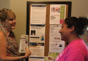 Judy Cocks talks to volunteer Maria Elizarraraz about social services. (Photo by Adela Crandell Durkee) 