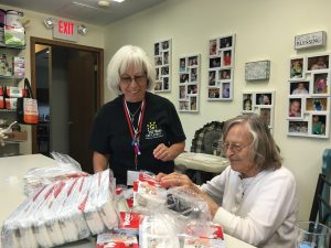 Marti Marshall and her Mother-in-law Alice Weber pack diapers. (Photo by Adela Crandell Durkee) 
